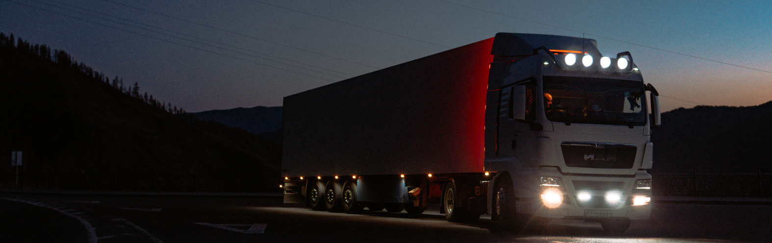 Freight truck on the road at dusk, part of the Chris Cargo & Logistics Limited transport fleet