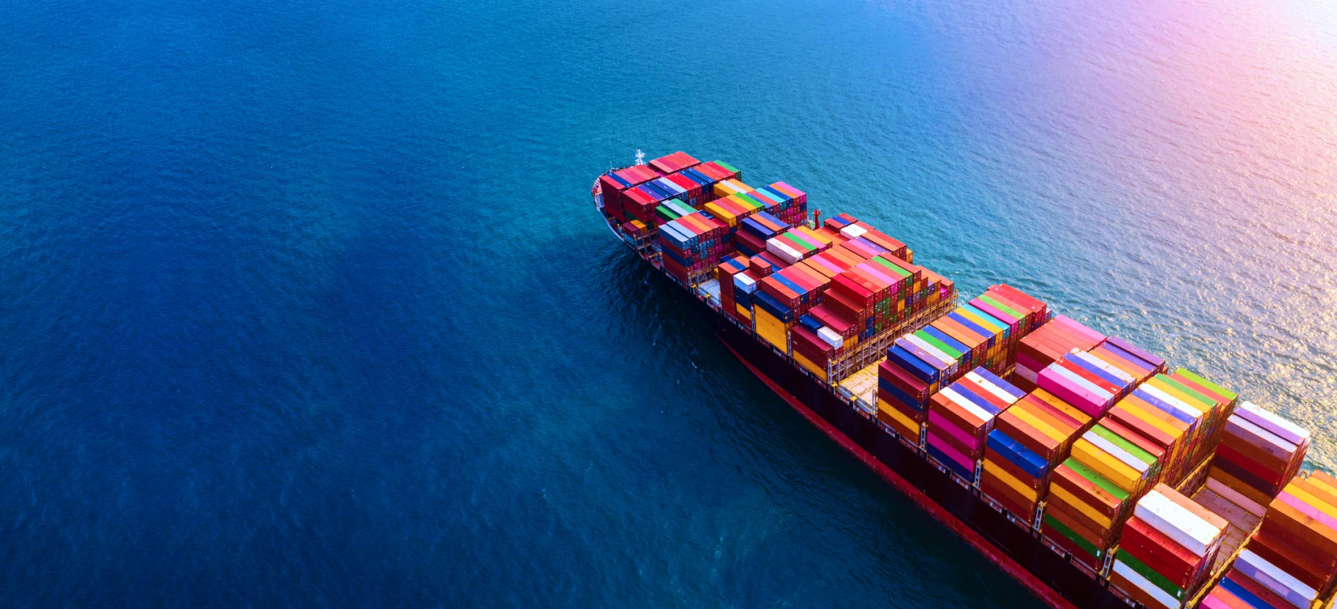 Aerial view of a fully loaded container ship at sea, representing Chris Cargo & Logistics Limited's global freight network
